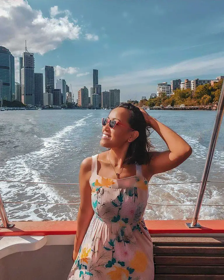 an image of a lady enjoying the ferry ride, one of the must do free activity in Queensland