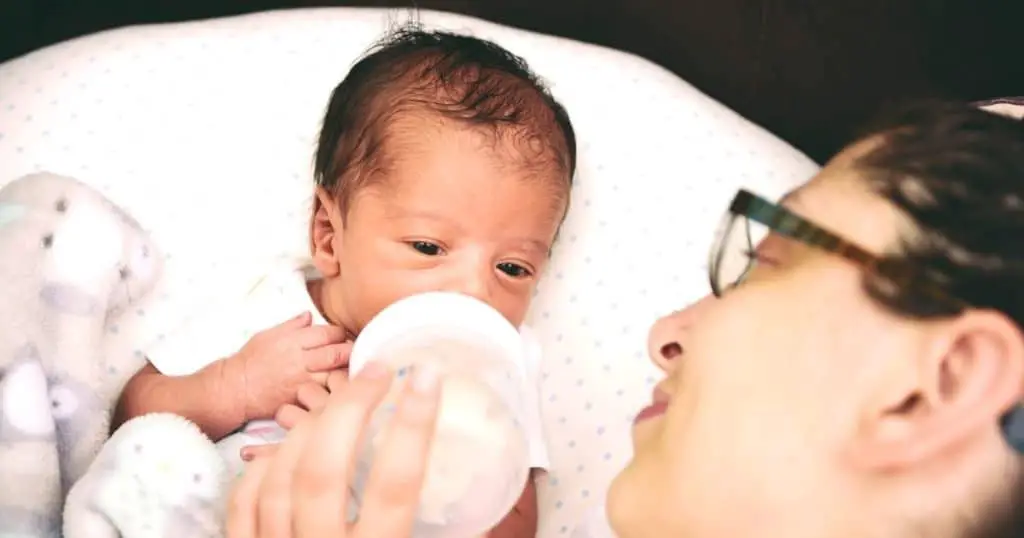 a mother feeding her infant using one of the best bottles for newborns