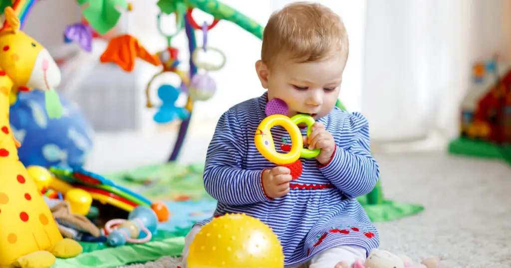 an image of a baby playing one of the best toys for 6 month old
